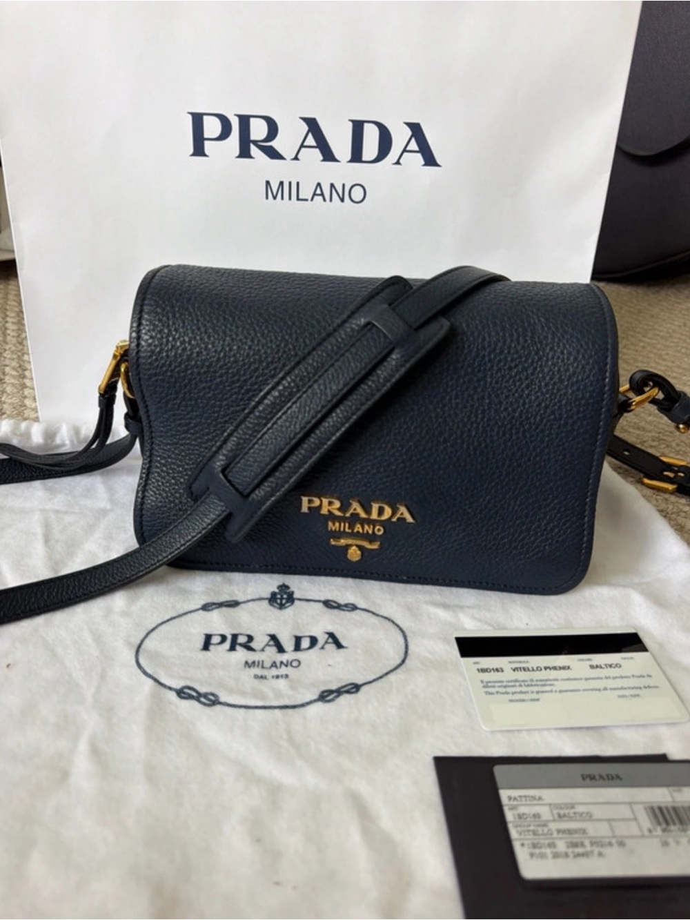 Prada Vitello Phenix flap crossbody, model 1BD163, in “Baltico” blue.